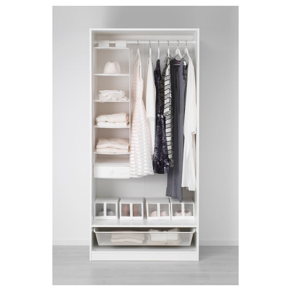 Open wardrobe with clothes, folded clothes, and storage boxes.