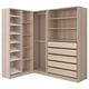 A modern corner wardrobe named PAX in light wood color, featuring shelving, drawers, and hanging space for clothes.