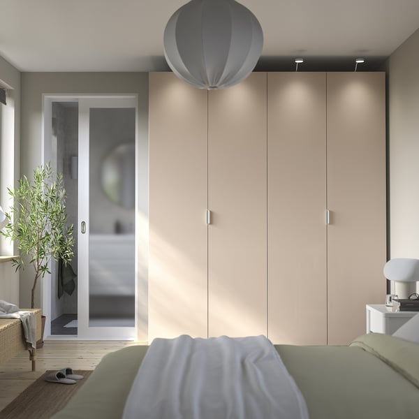 Modern bedroom with PAX wardrobe, green bed, balcony, and hanging lamp.