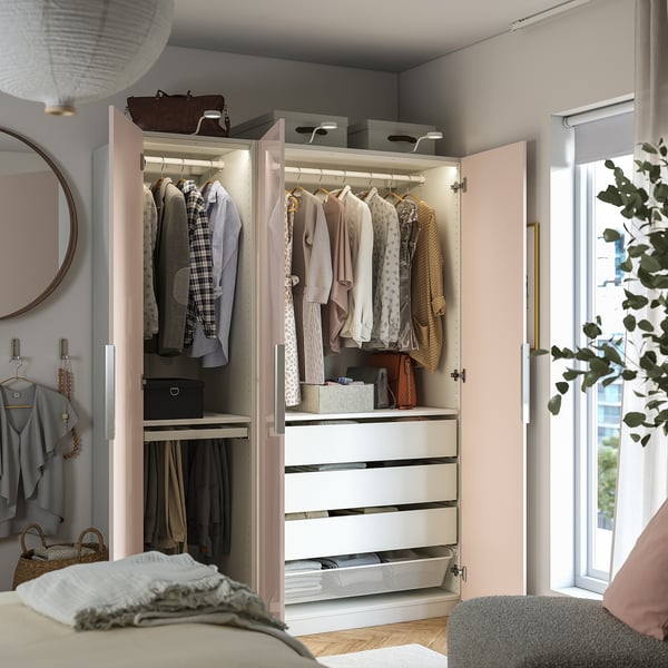 A modern wardrobe with light, clothes, and shelves. Interior drawer and baskets organise clothes.