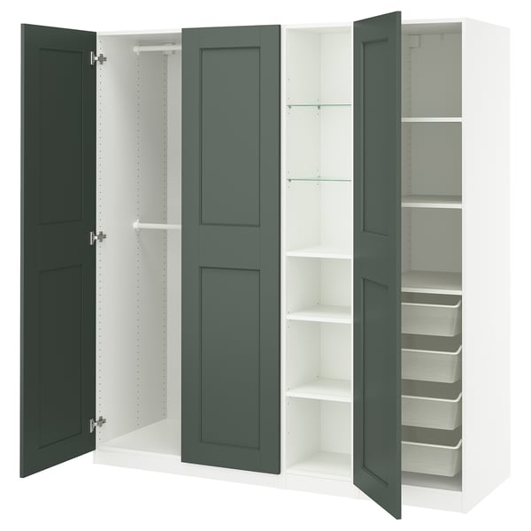 An open, dark green PAX wardrobe with multiple storage compartments, including shelves and a clothes rail.