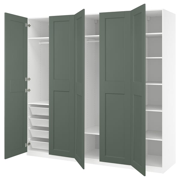 A green PAX wardrobe with open doors revealing shelves and drawers.