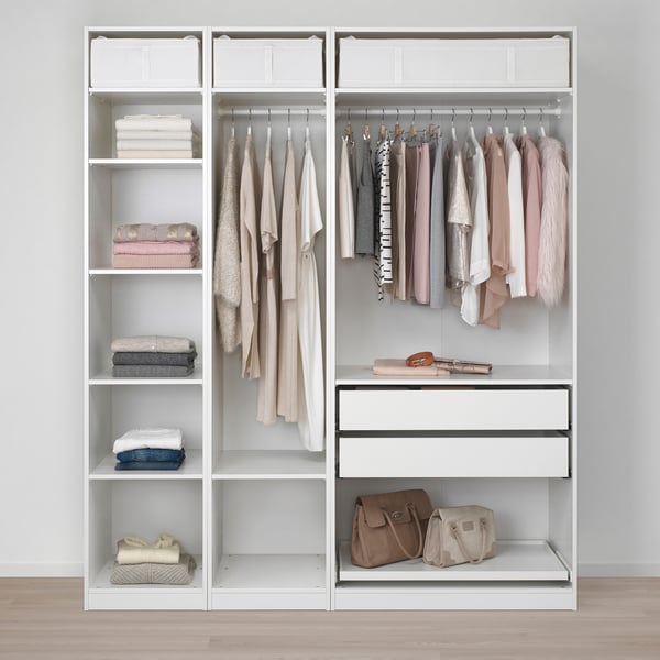 Organised closet with shelves, hanging rods, and drawers. Clothes are neatly arranged, showing efficient storage and easy access.