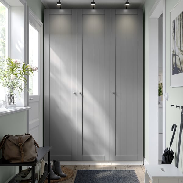 Grey PAX wardrobe with multiple doors, focal point of furniture setup.