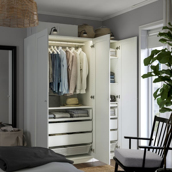 Open closet displaying clothes, drawers, and mesh basket. Integrated lighting, adjustable feet.