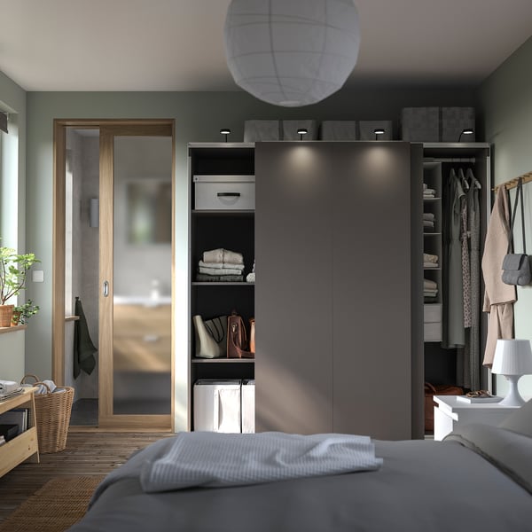 Modern bedroom with PAX wardrobe, green walls.