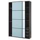 A black ikea PAX wardrobe with blue-tinted sliding glass doors and open shelves on the right side.