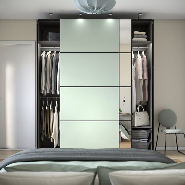 Modern sliding mirror wardrobe with lighting, shelves, and adjustable feet.