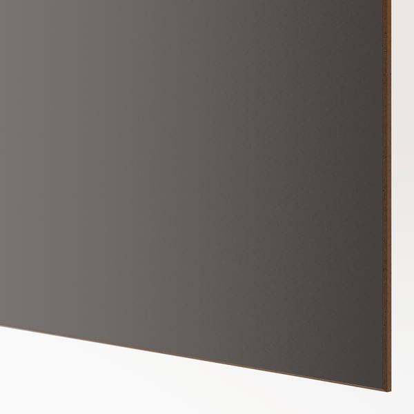Close-up of sleek, modern wardrobe with smooth, dark finish, showcasing high-quality material and design.