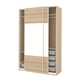 A light wooden PAX wardrobe with sliding doors and shelves. The design is minimalist and functional.
