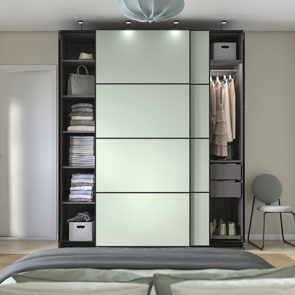 Modern bedroom with PAX wardrobe, sliding doors, organised clothes, lighting.