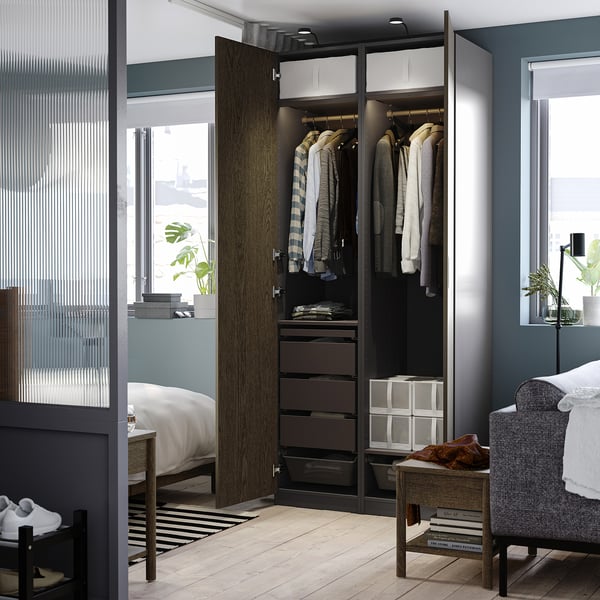 Open wardrobe with clothes and storage; shows hinged doors closing softly, adjustable feet, and drawers.