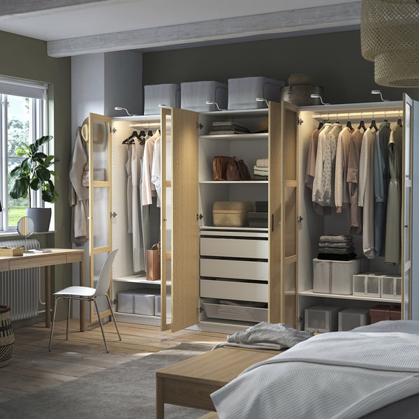 Modern bedroom with organised PAX closet showing clothes, shelves, and drawers.