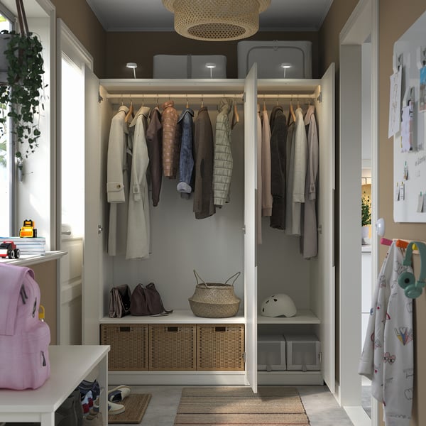 Closet with hanging coats, baskets, and shelves. Soft-closing doors and integrated lights.