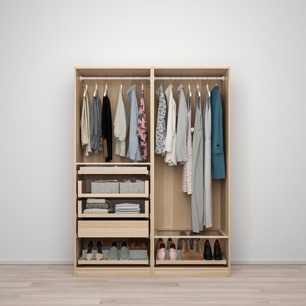 Open wooden wardrobe with hanging clothes, foldable clothes, accessories, and shoes organised on shelves and drawers.