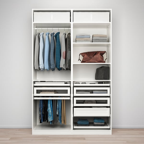 White PAX wardrobe organising clothes with hanging rail, drawers, and shelves, efficiently utilising space to store various items.
