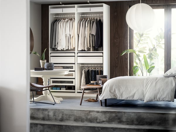 Minimalist bedroom with PAX wardrobe, bed, plants. Alternatively, for even fewer characters: minimalist bedroom with wardrobe and bed.