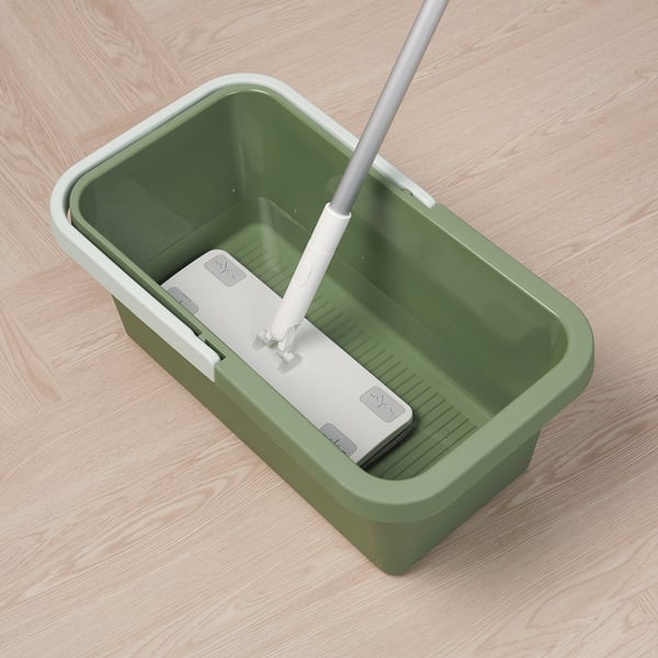 Green mop bucket with a white mop handle inserted, designed for cleaning and organising tools.