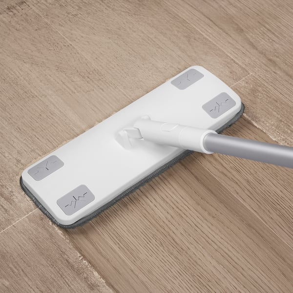White microfiber mop with telescopic handle cleans floors, glass, and gaps. Adjustable, effective, and easy to use.