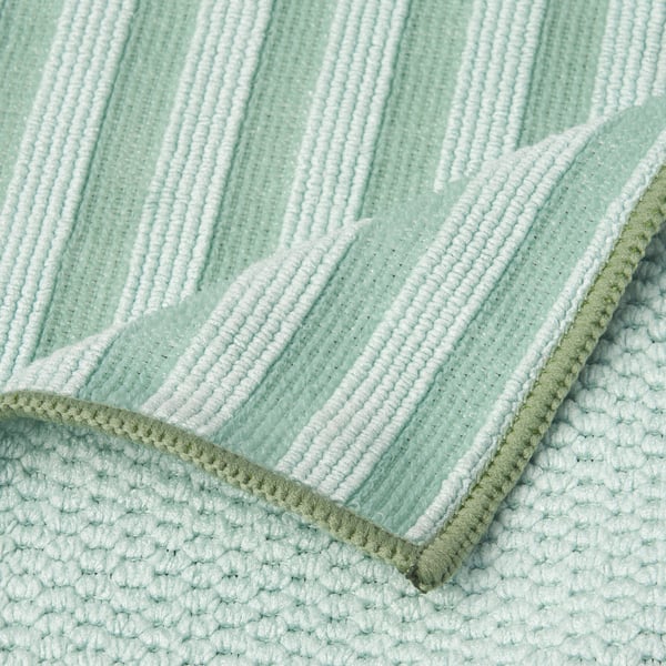 Close-up of soft, textured, light green & white striped microfiber cloth with double-stitched edges.