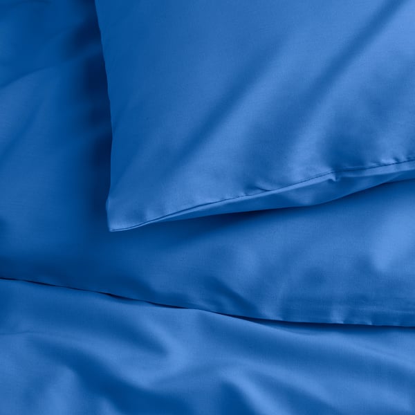 Crisp blue bedding set, neatly folded, showcasing smooth, wrinkle-free fabric.