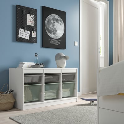 Modern room with PJÄTTERYD black-and-white moon poster, white storage unit, and skateboard.