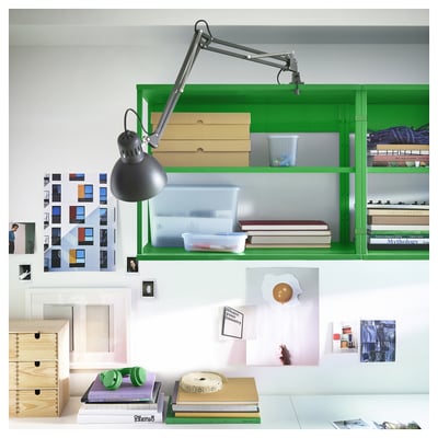 Green PLATSA shelf unit with lamp, books, and decor.