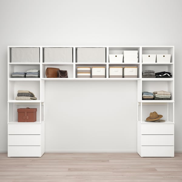 White modular storage system, adjustable to fit various spaces, featuring shelves with neatly organised clothes, accessories, and storage boxes.