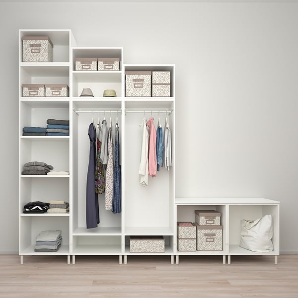 Modern closet with shelves, hanging rods, and storage boxes for organised clothing.