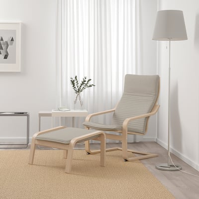 Pocoang armchair & footstool: lightwood, cream cushions; cosy, simple design; large, near window; lamp & decor beside.