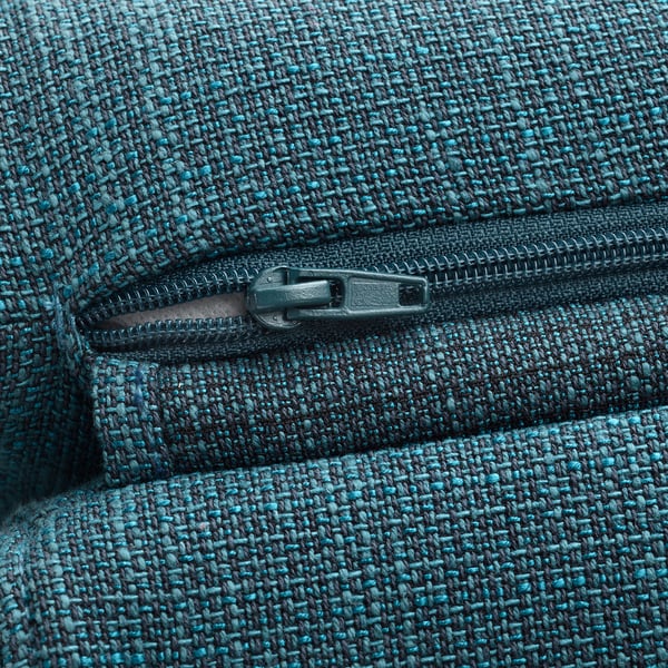 Close-up of high-quality, textured teal-blue fabric with a detailed black zip pull, showcasing craftsmanship and durability.