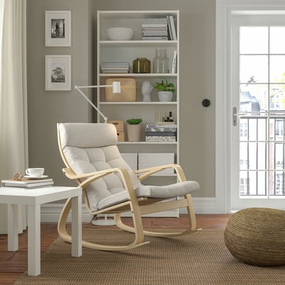 Cosy room with POÄNG rocking chair, bookshelf, and large window.