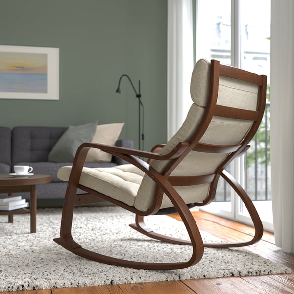 Modern rocking chair, POÄNG, with cushioned seat in cosy living room.