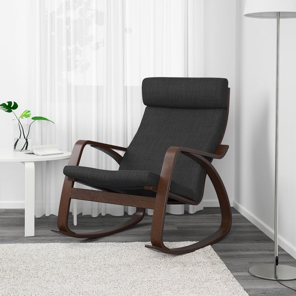 A modern dark grey rocking chair with a wooden frame sits on a rug, offering comfort and elegance.