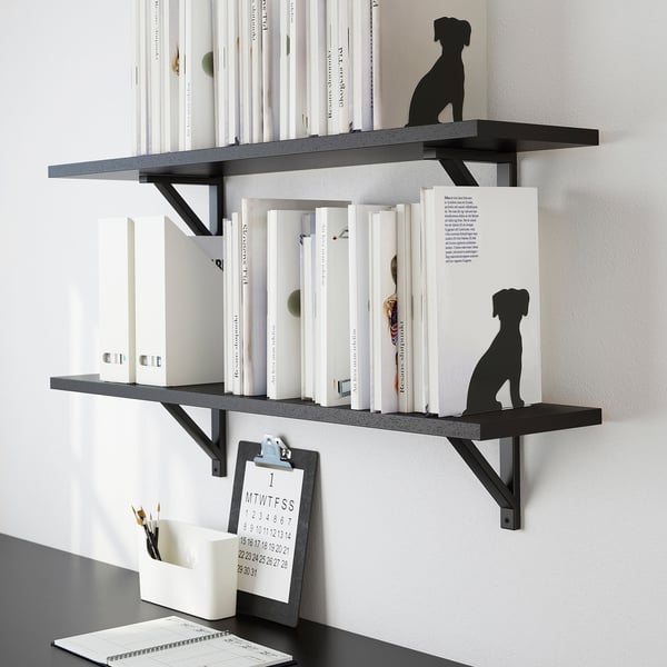 Wall-mounted shelves with black dog bookends keep books upright. Includes a clipboard with calendar and pen holder.