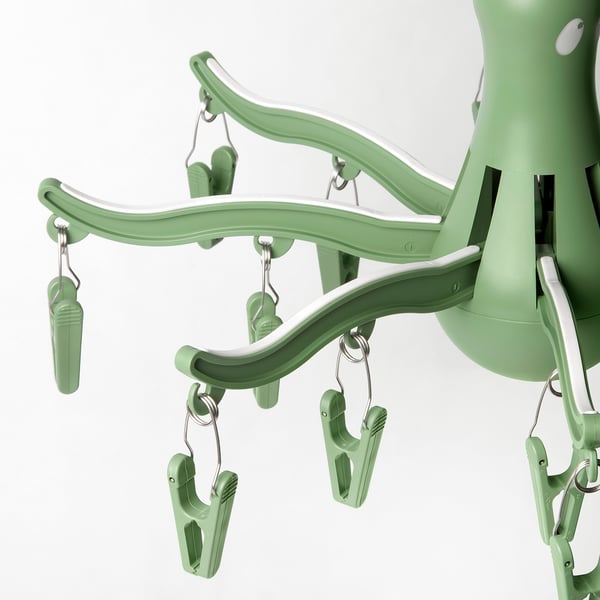 Green plastic sock dryer, 16 clips attached, neat design.