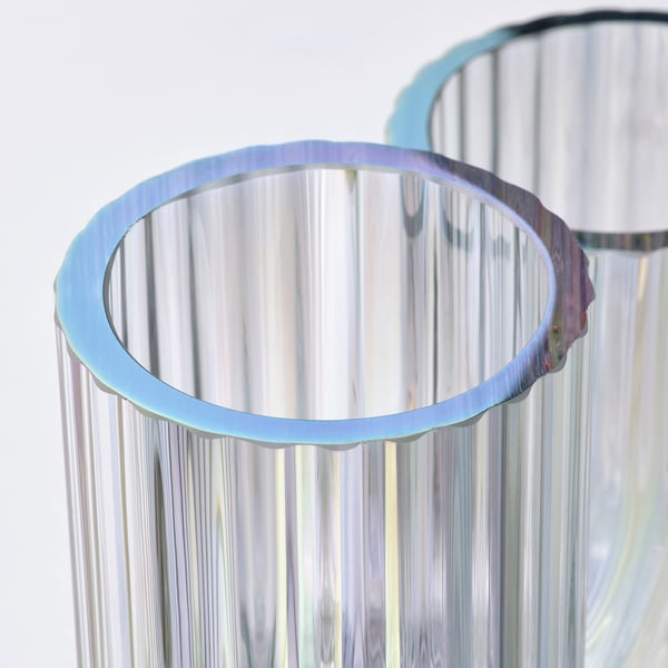 Rainbow-colored, ribbed glass vase. Playful, flowing design. Two sizes, reflective finish.