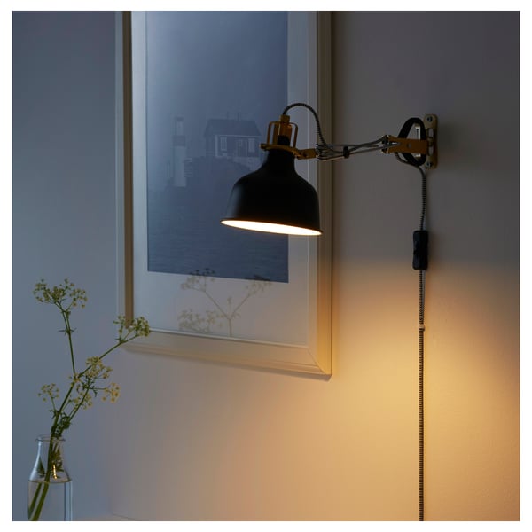 Adjustable wall lamp RANARP with black shade and warm light.