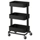 An ikea RÅSKOG, a black, three-tiered mobile storage cart with lockable wheels, ideal for kitchen and desk use.