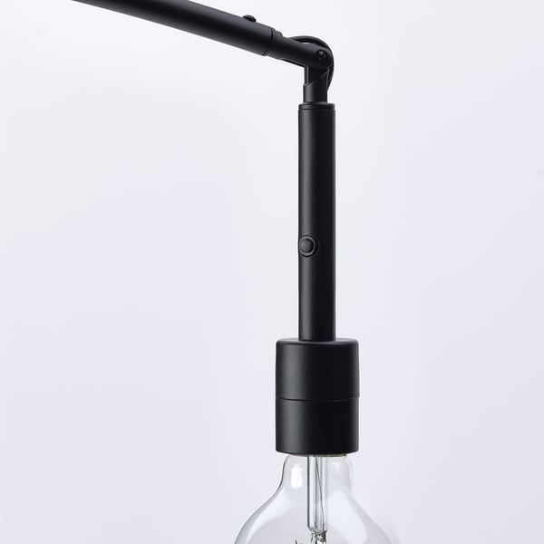 Black modern floor lamp with adjustable neck and exposed light bulb.