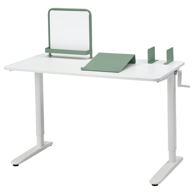 Adjustable white desk with green accessories, magnetic whiteboard, writing pad, and bookends. Crank handle adjusts height 65-108 cm.
