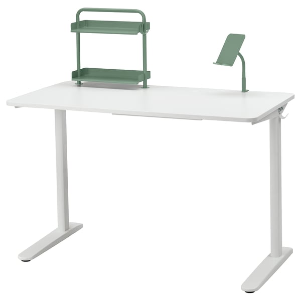 A white RELATERA desk with green accessories including a shelf and phone/tablet holder.