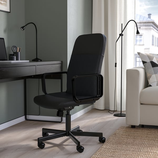 Black RENBERGET office chair between desk and couch, medium size.