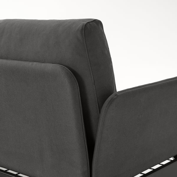 Close-up of a modern, upholstered chair backrest and armrest. Dark textile, sleek design.