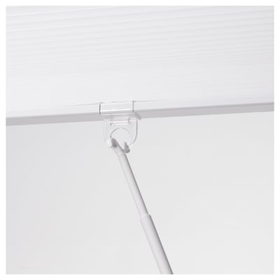 Clear plastic rod clipping onto a white fabric blind, allowing easy control and adjustment.