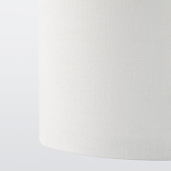 Close-up of clean, minimalist lamp shade with smooth, white textile and precise cut.