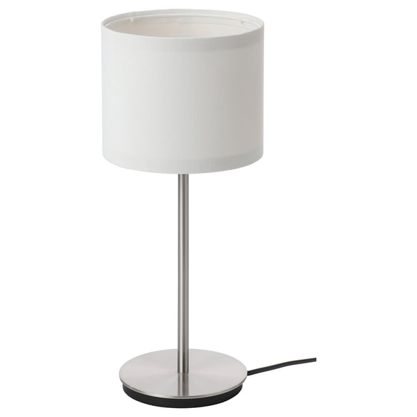 A modern white lamp, named RINGSTA. It a slim metal base and a cylindrical lampshade, emitting soft light.