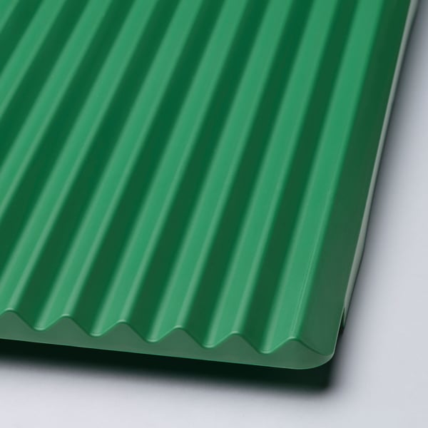 Close-up of green, corrugated dish drainer, showcasing quality design and material.