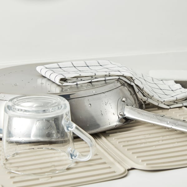 Kitchen mat with dishes and glass.