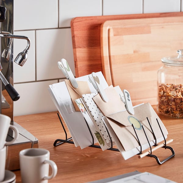 Kitchen counter with RINNIG dish holder, plates, coffee maker, mug, and snack jar.